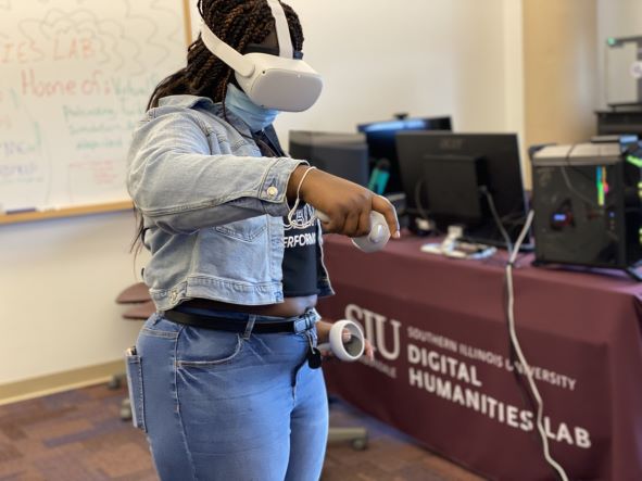 student standing up and using a virtual reality headset